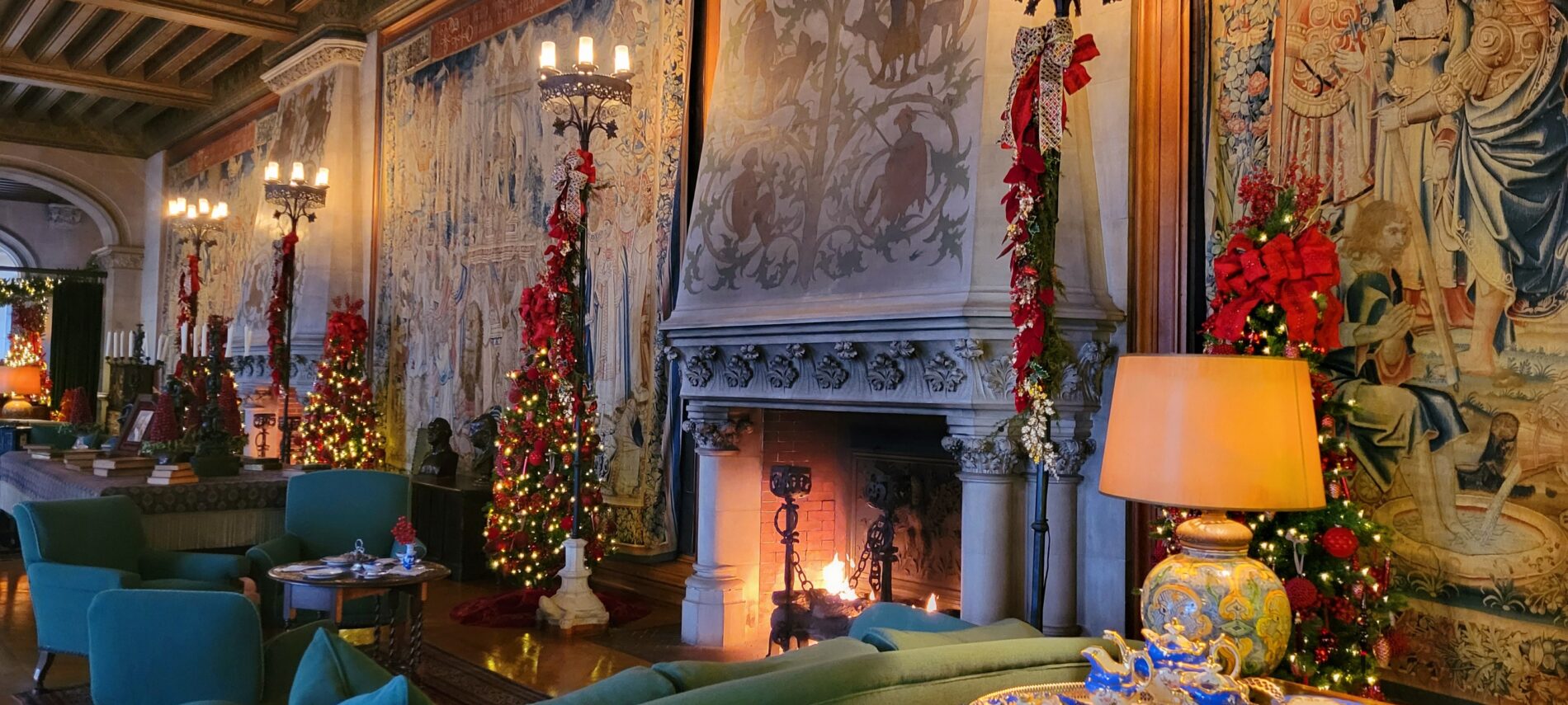 Biltmore House Tapestry Gallery decorated for Christmas with fireplaces lit