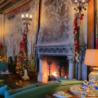 Biltmore House Tapestry Gallery decorated for Christmas with fireplaces lit