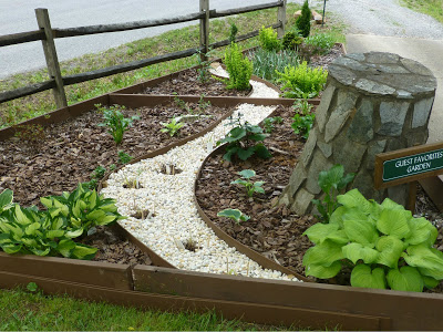 Garden with gravel and frame forming a dry stream through the middle