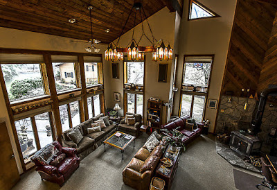 Large room with several couches and floor to ceiling windows