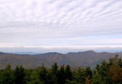 View of mountain ridge with a sky full of lines of clouds