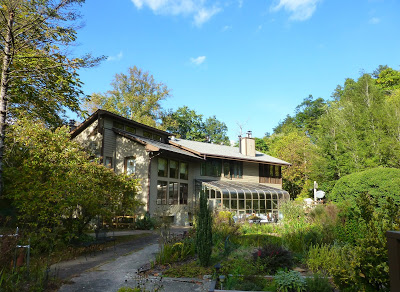 Lodge style bed & breakfast surrounded by lush green foliage