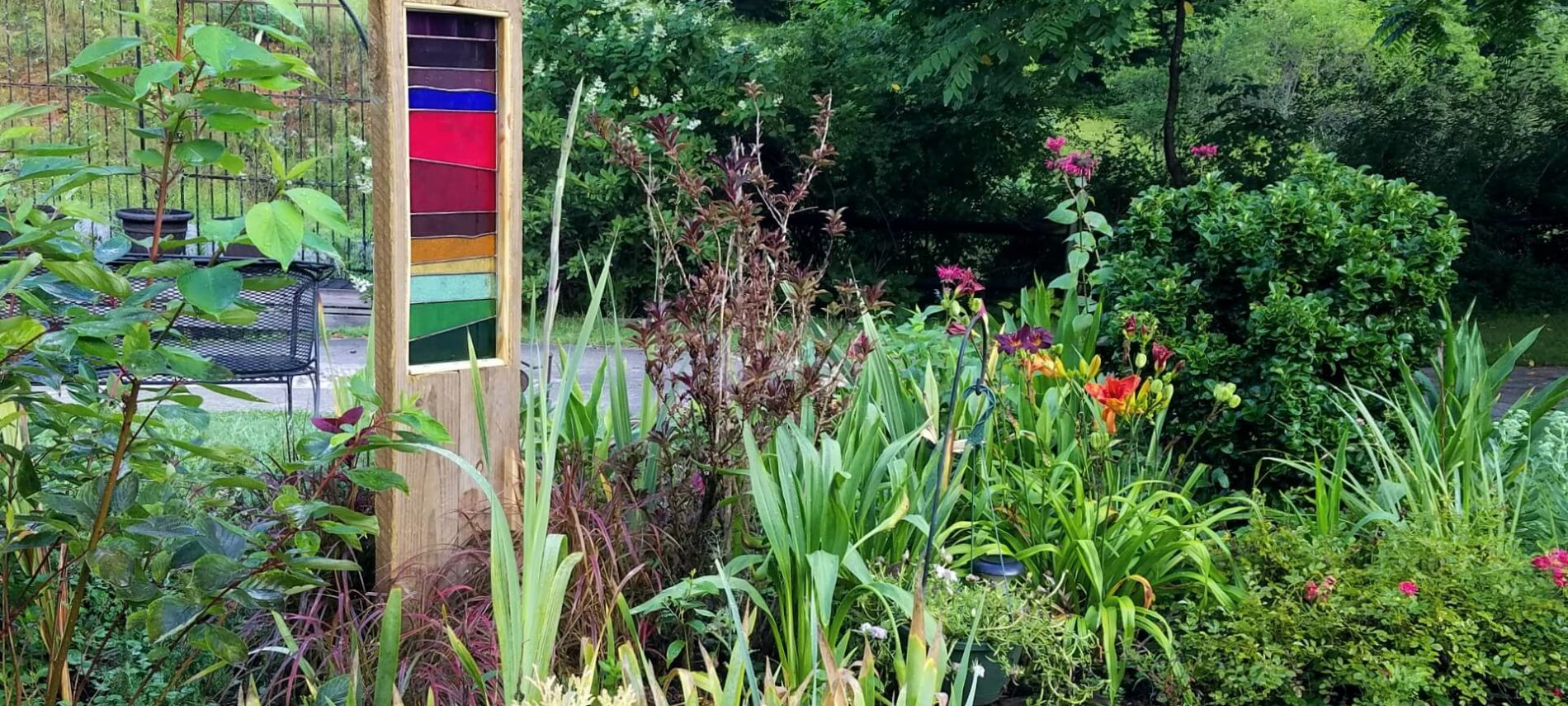 Multi-colored stained glass framed in wood in a garden