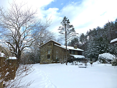 Snow covered landscape with lodge style B&B in the background