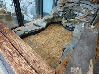 Plywood covering empty oblong fish pond