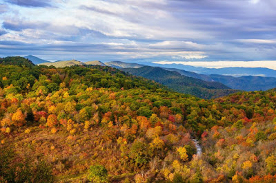 View of mountain ranges in varying shades of orange, green and red
