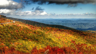 Mountain vista with vibrant fall color on some ridges and subtle green on others