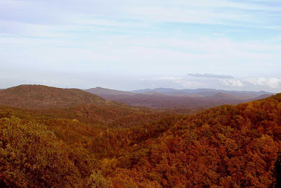 View of mountain ranges in striking orange and red fall colors