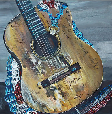 Painting of a guitar with autographs on it and a red, white and blue guitar strap